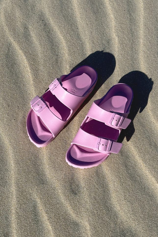 Baby pink sandals on beach