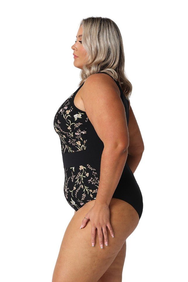 Model showing side of black wildflowers zip up one piece