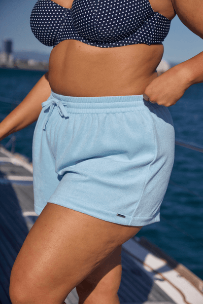 Side profile of model wearing flattering terry towelling shorts in terry towelling australia