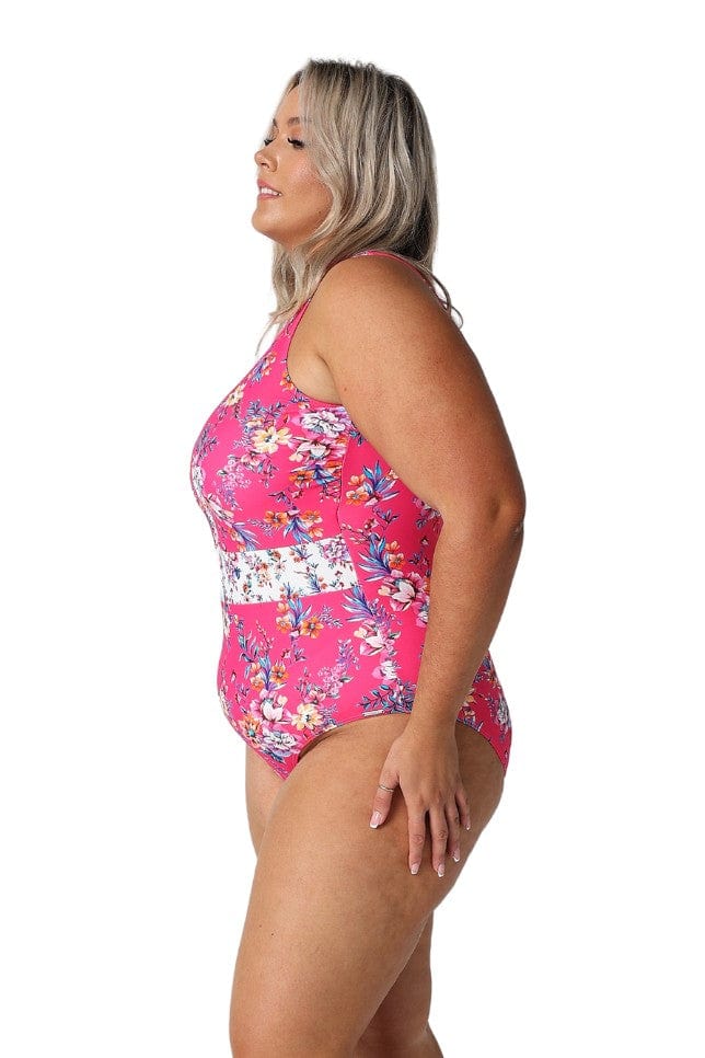 Model showing side of hot pink floral sleeveless one piece