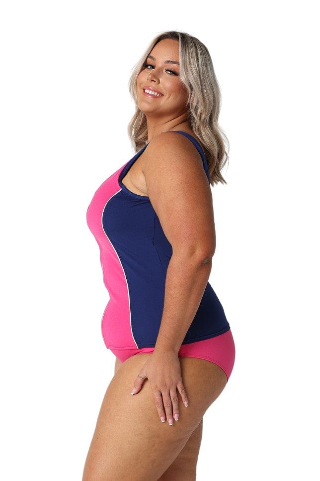 Side profile of blonde model in studio wearing navy and pink tankini top for curvy woman
