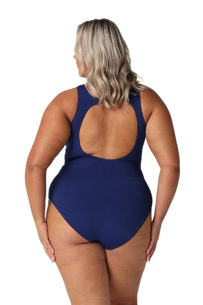 Curvy woman showing back navy plus size swimsuit with scoop back in chlorine resistant