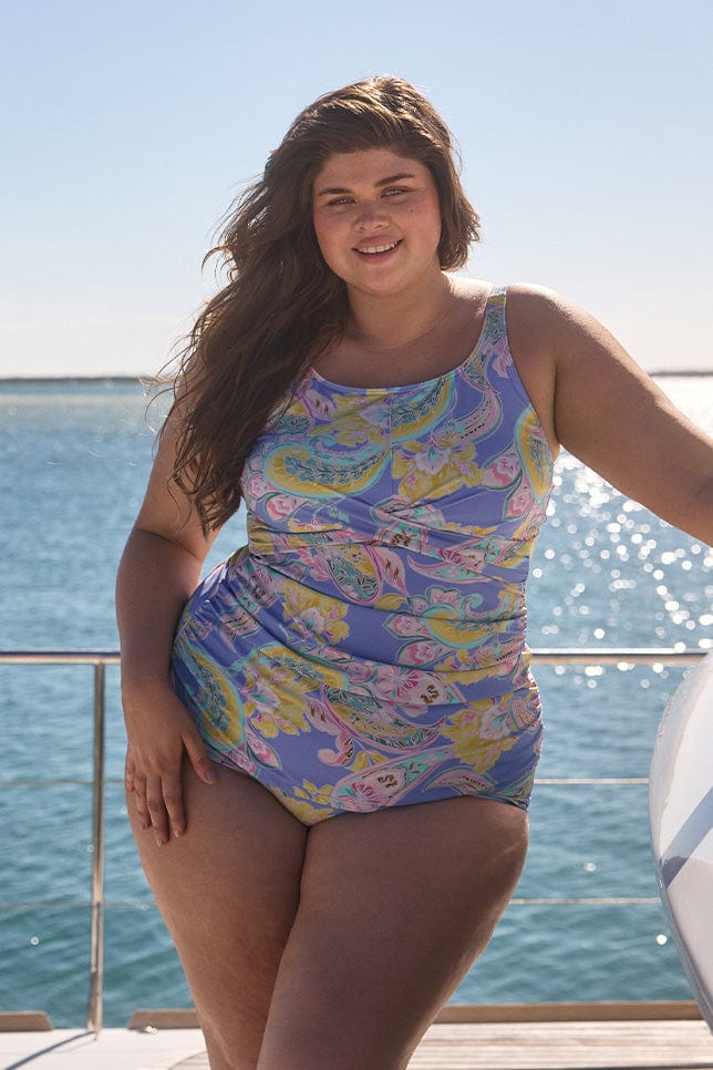 Brunette model wearing a ruched high neck tankini top for curve women