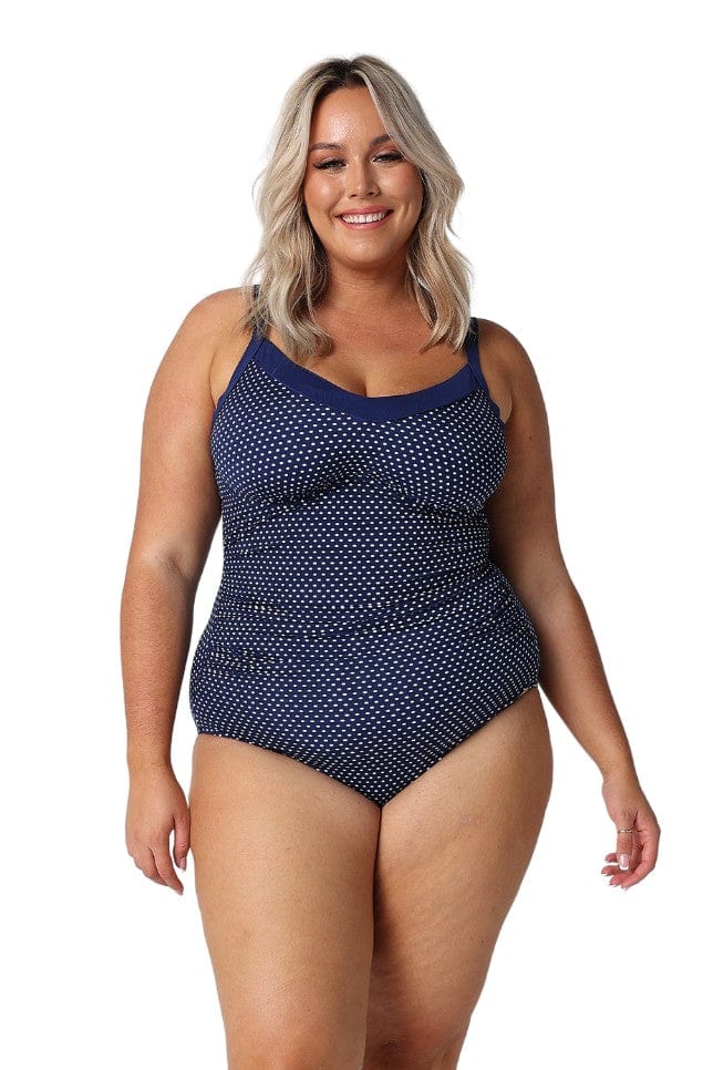 Model wearing navy and white dots underwire one piece
