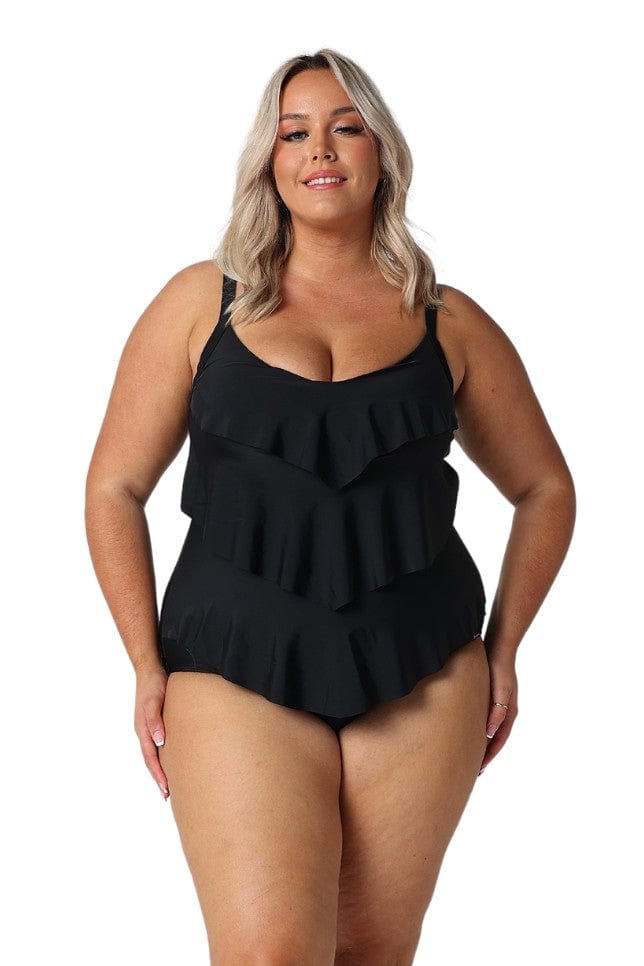 Blonde model wearing black 3 tier one piece swimsuit