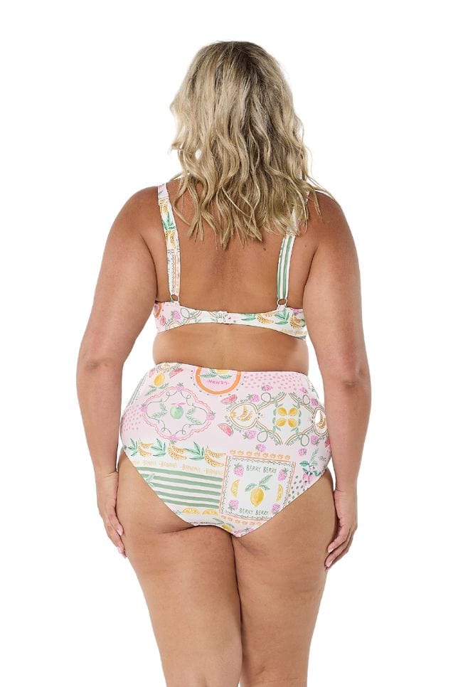 Back of model wearing high waisted belly pant in fruit print