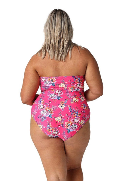 Model wearing hot pink floral shirred bandeau one piece