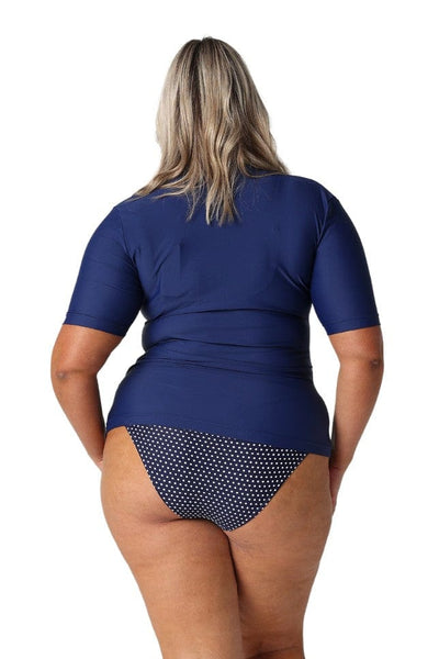 Blonde model wearing navy short sleeve rash vest