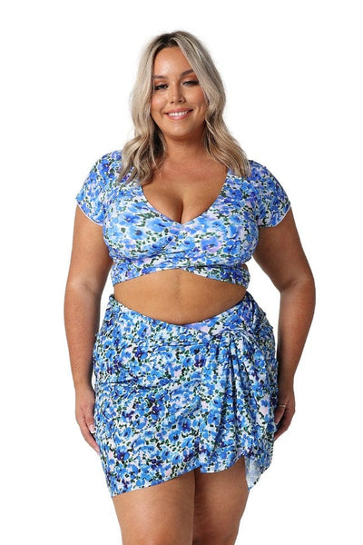 Front of model wearing sarong in blue and white floral