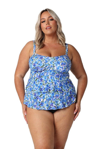 In studio model wearing ruffled tankini top in blue and white flower print for curve women