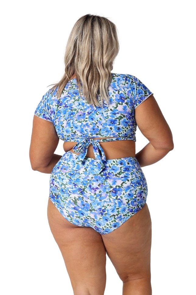 Back of curve model in studio wearing high waisted floral print swim pant