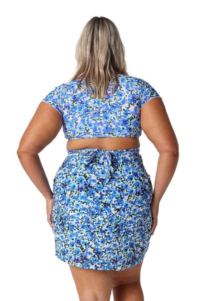 Back of blonde model in studio wearing plus size sarong with tie wrap detail