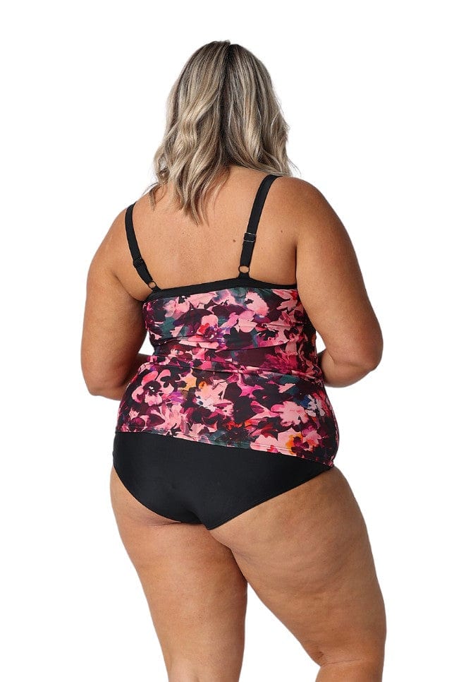 Model in studio wearing supportive pink floral underwire tankini top