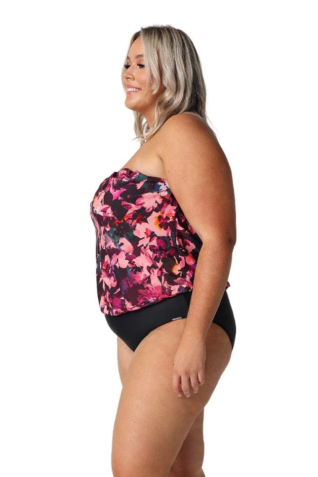 Side of model wearing pink floral bandeau one piece with removable straps