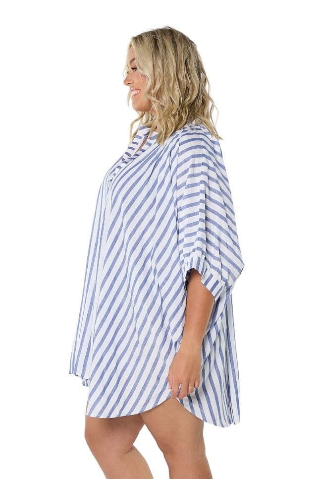 Side profile of plus size model in blue white striped beach shirt with v neckline