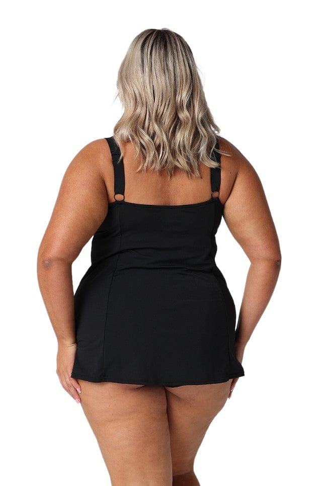 Back of model in studio wearing plus size pool proof swim dress with adjustable pant in floral print Australia