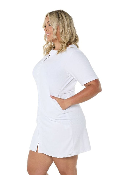 Side of model wearing white terry towelling dress with zip front detail for curve women