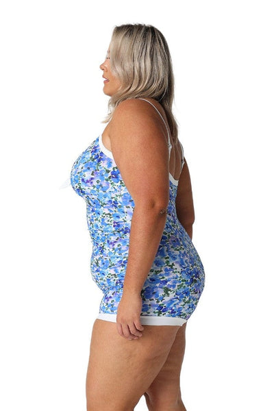 Side profile of plus size model wearing retro boyleg one piece in blue and white watercolour floral print