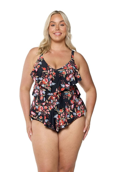 Model in studio wearing three tiered swim tankini top for plus size women in red pink florals