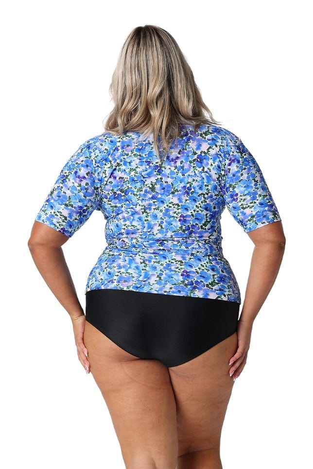 Back of curve model wearing water coloured floral print in short sleeve rash vest