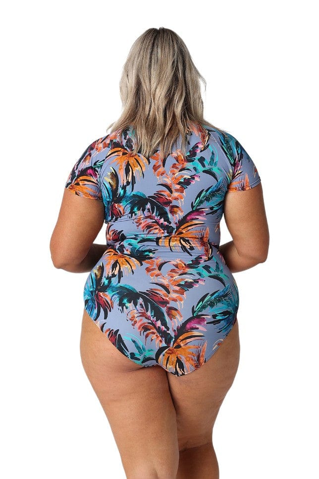 Blonde plus size model in studio wears blue grey floral print cap sleeves with tie front one piece