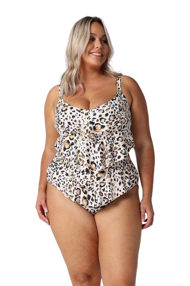 Blonde model in studio wearing tiered one-piece in black white and orange animal print swimsuit