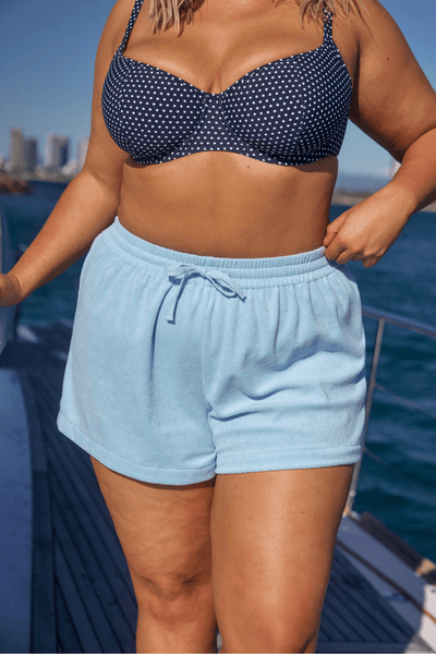 Close up image of model wearing plus size terry towelling beach short with drawstring 