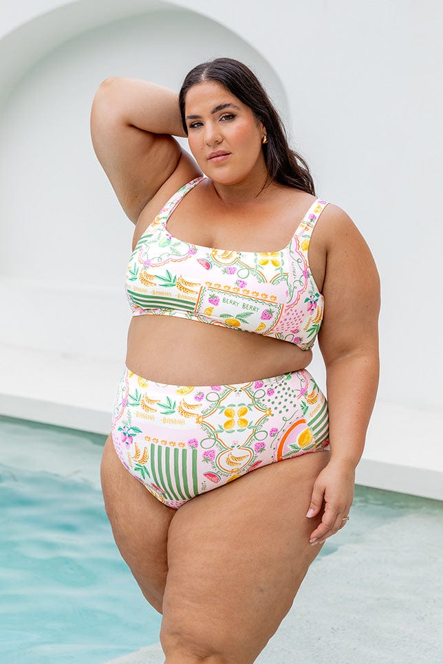 Brunette plus size women wearing fruit multi coloured swim pant 