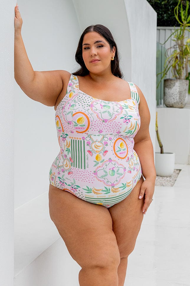 Brunette plus size model wearing square neck one in bright fruit print