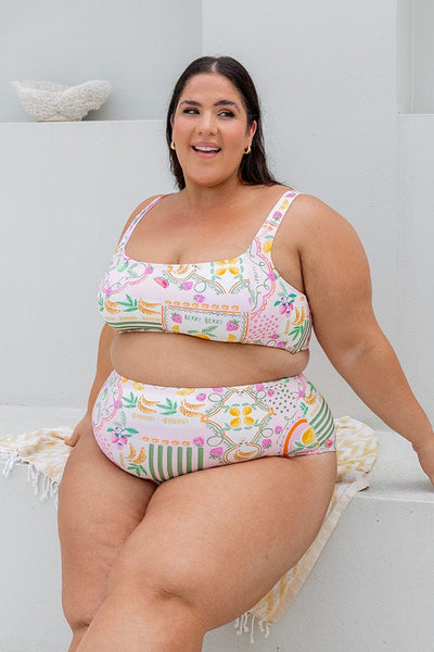 Brunette plus size women wearing flattering fruit multi coloured bikini top