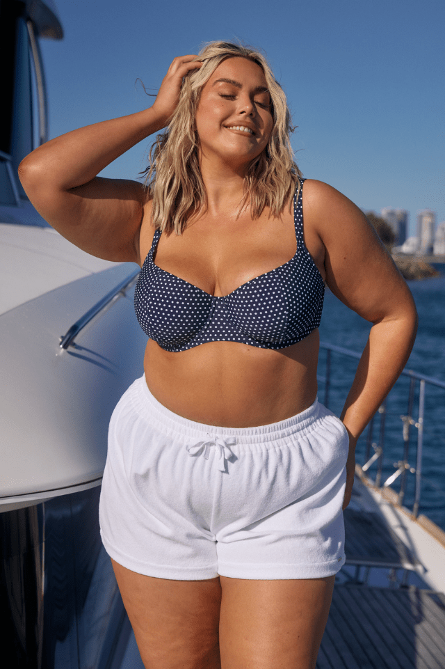 Blonde model on boat wearing terry towelling plus size shorts with drawstring