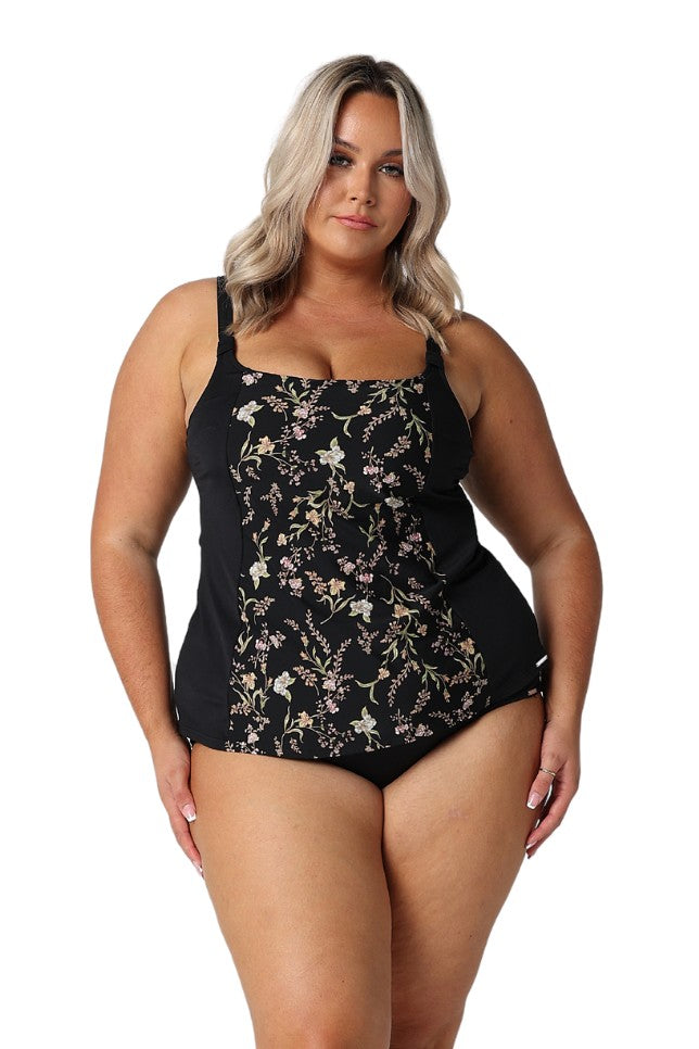 Model wearing black floral tankini top