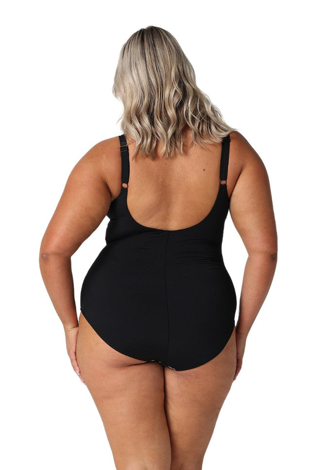 Model showing low back of black floral swimsuit