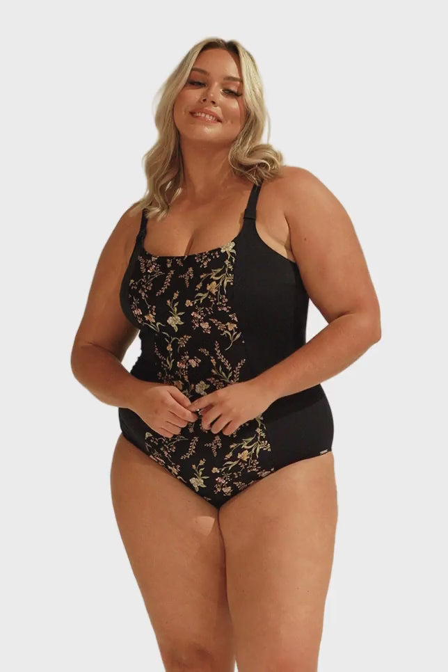 Model wearing black floral chlorine resistant one piece