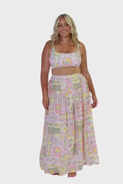 Blonde plus size women wearing long maxi skirt in multi coloured fruit print