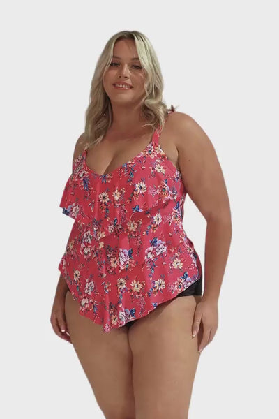 Model wearing hot pink floral 3 tier tankini top with black bottoms