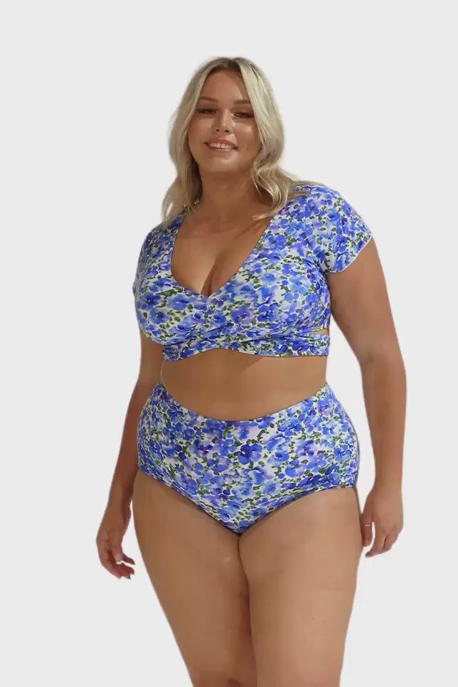 Video of plus size model wearing curvy wrap crop top with tie detail and v neckline