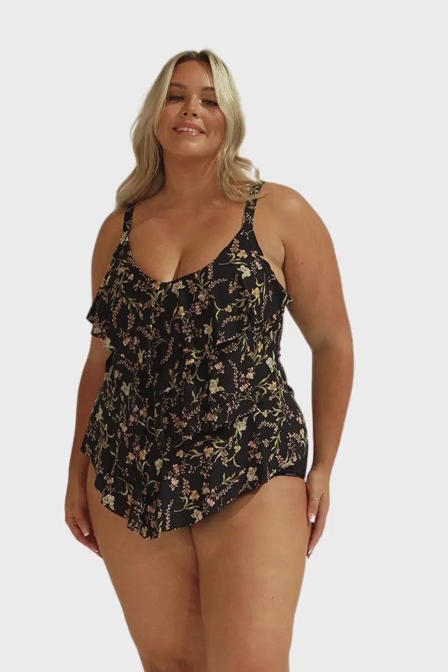 Model wearing black wildflower floral ruffle tankini top