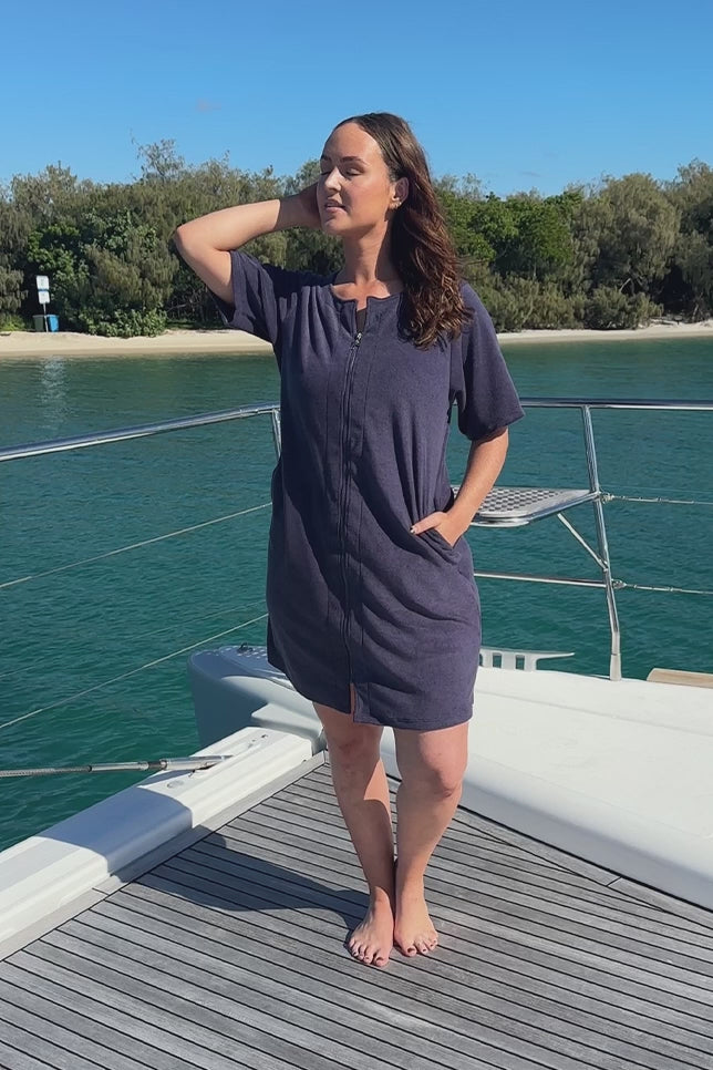 Video of a model wearing a flattering terry towelling navy beach dress with zip