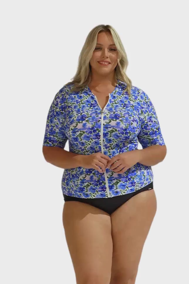 Plus size model wearing blue and white rash vest with zip front detail