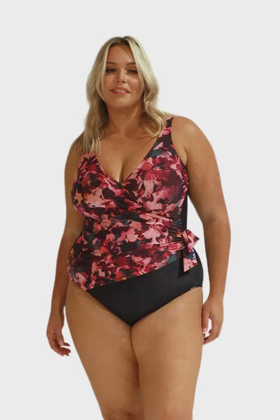 Video of blonde model in studio wearing curvy one piece tie side detail one piece with floral print in pink and black