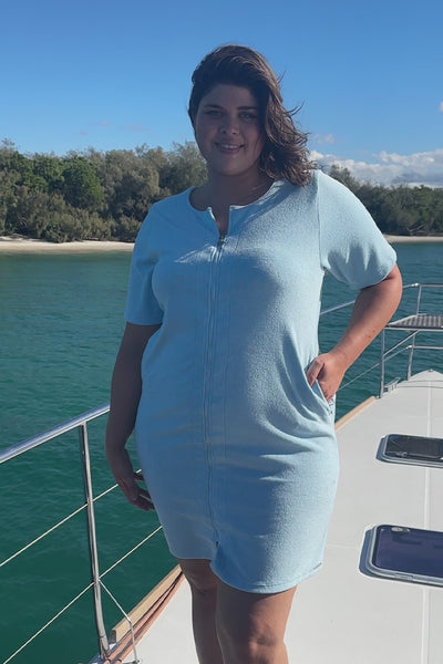 Video of model wearing short sleeve baby blue zip through beach coverup dress for plus size woman