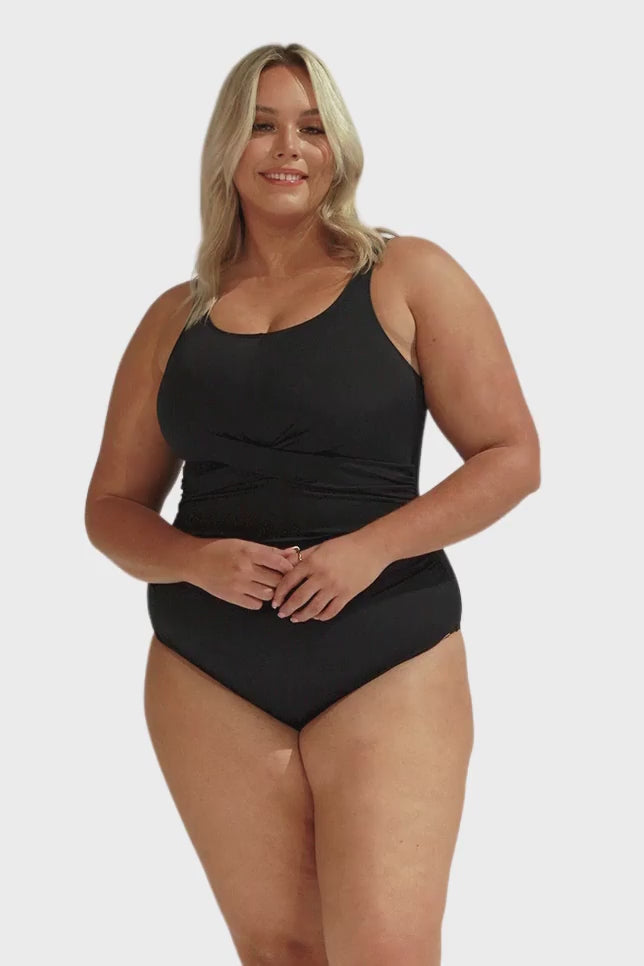 Video of blonde model in studio wearing plus size one piece with ruching twist front detail in chlorine resistant