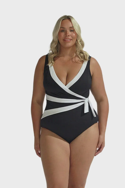 Blonde model wearing black and white waist tie one piece